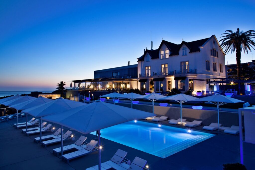 Farol Hotel: vista externa, dos fundos do hotel com vista para o mar e sua piscina de borda infinita.