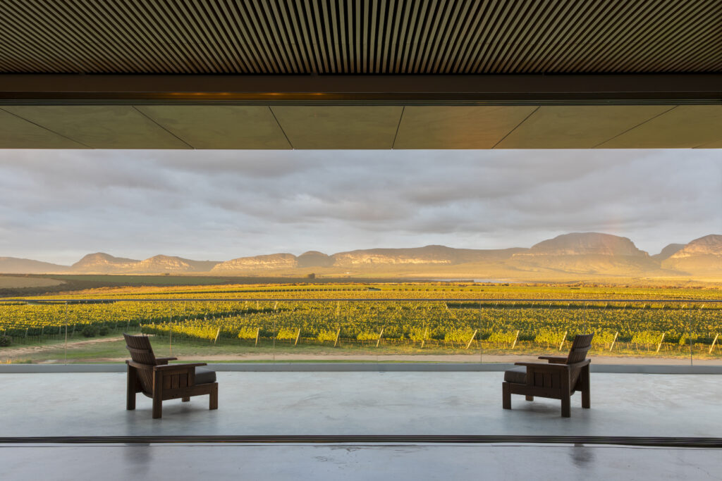Área externa moderna na vinícola Uvva, Mucugê, Bahia, com vista para vinhedos e montanhas