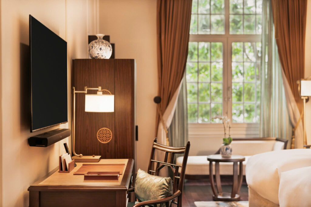 Detale de marcenaria clássica e escrivaninha em suíte de luxo no Sofitel Legend Metropole, destaque entre os hoteis em hanoi.