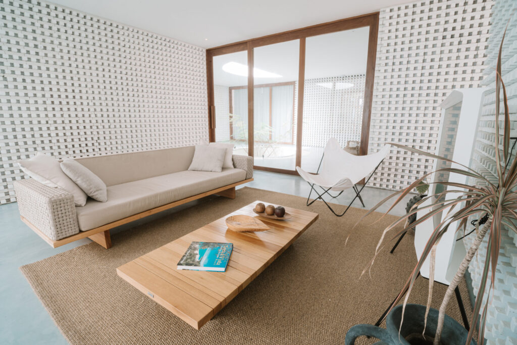Sala de estar com design contemporâneo e mobiliário em madeira, conforto premium em hoteis em são miguel do gostoso.