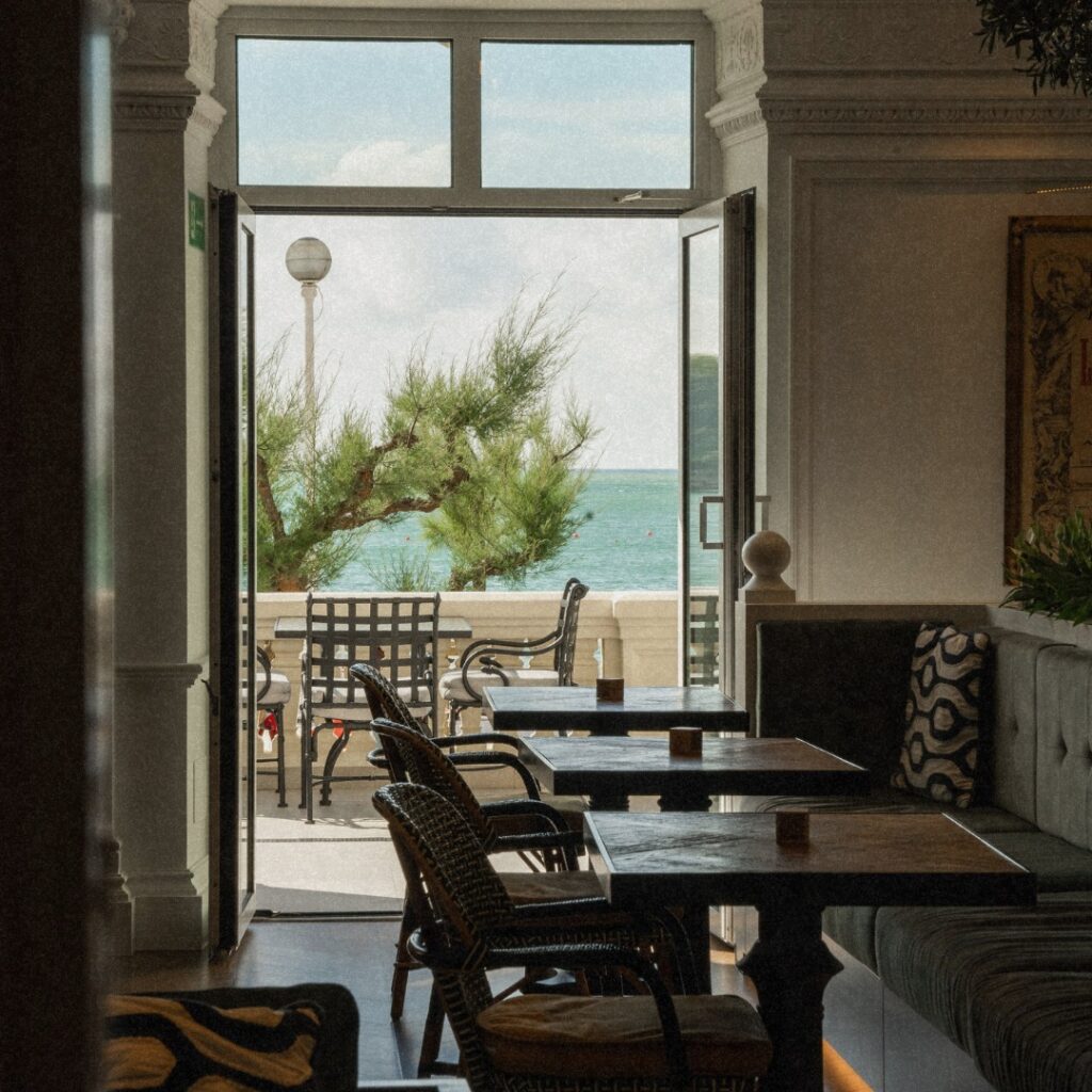 Restaurante elegante no Hotel Villa Favorita San Sebastian com móveis de madeira e vista para o mar.