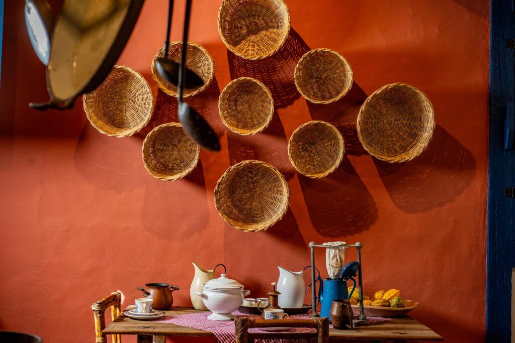 Decoração de parede com cestaria e mesa de café posta na Pousada Literária.