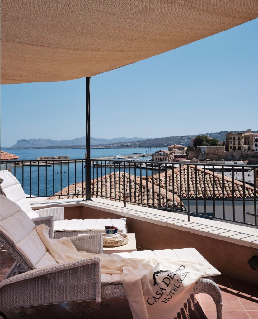 Terraço com vista para o mar e porto histórico no Casa Delfino, um dos melhores hoteis da ilha de creta.