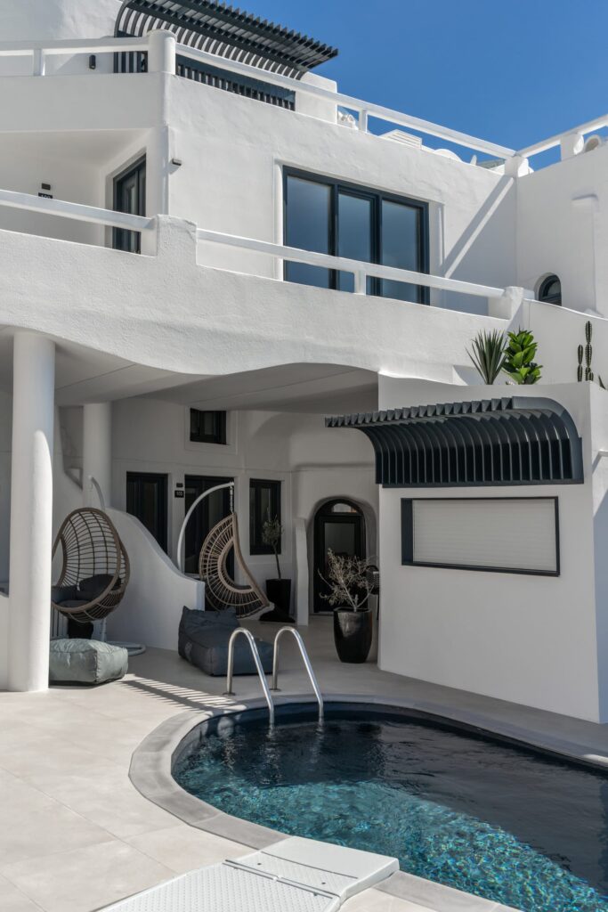 Piscina privativa e poltronas suspensas em terraço de design em hoteis boutique em santorini.