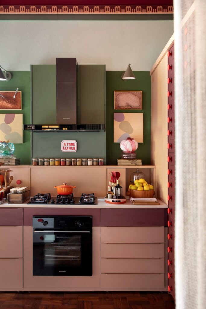 Cozinha gourmet da Casa Brastemp na Casacor São Paulo 2026 com marcenaria rosa queimado, cooktop preto e parede verde-oliva.