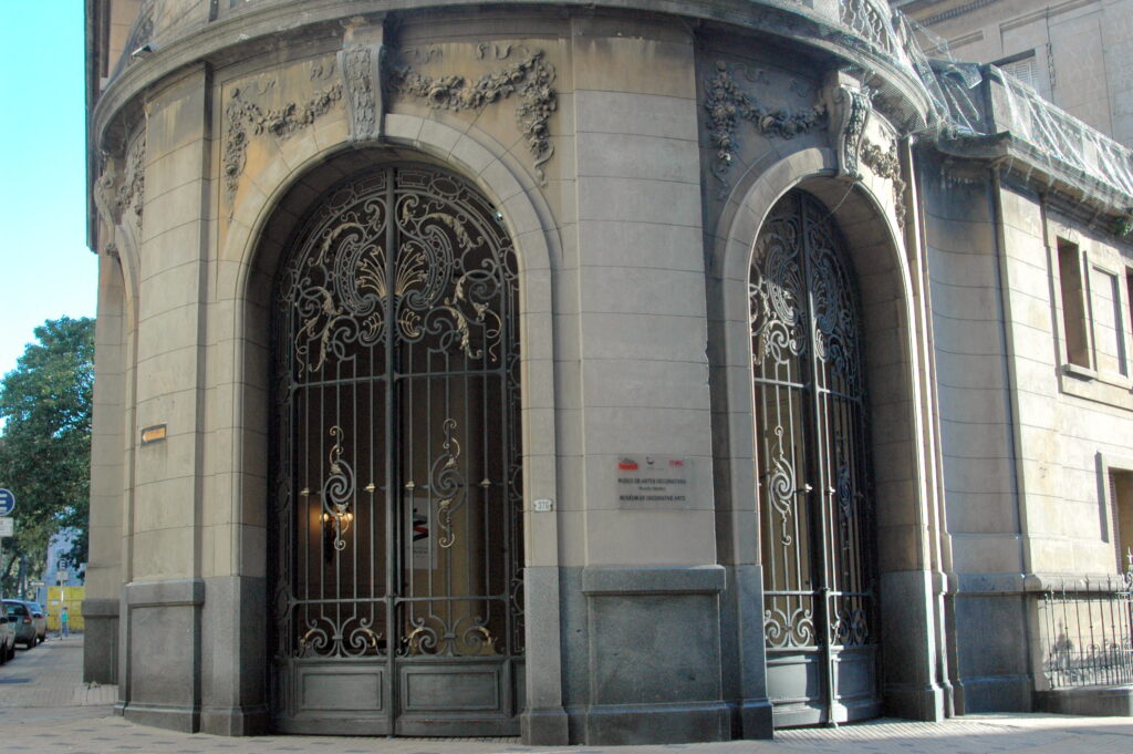 Entrada monumental do Palácio Taranco com portões em arco de ferro forjado em Montevidéu, parada cultural de roteiro no Uruguai.