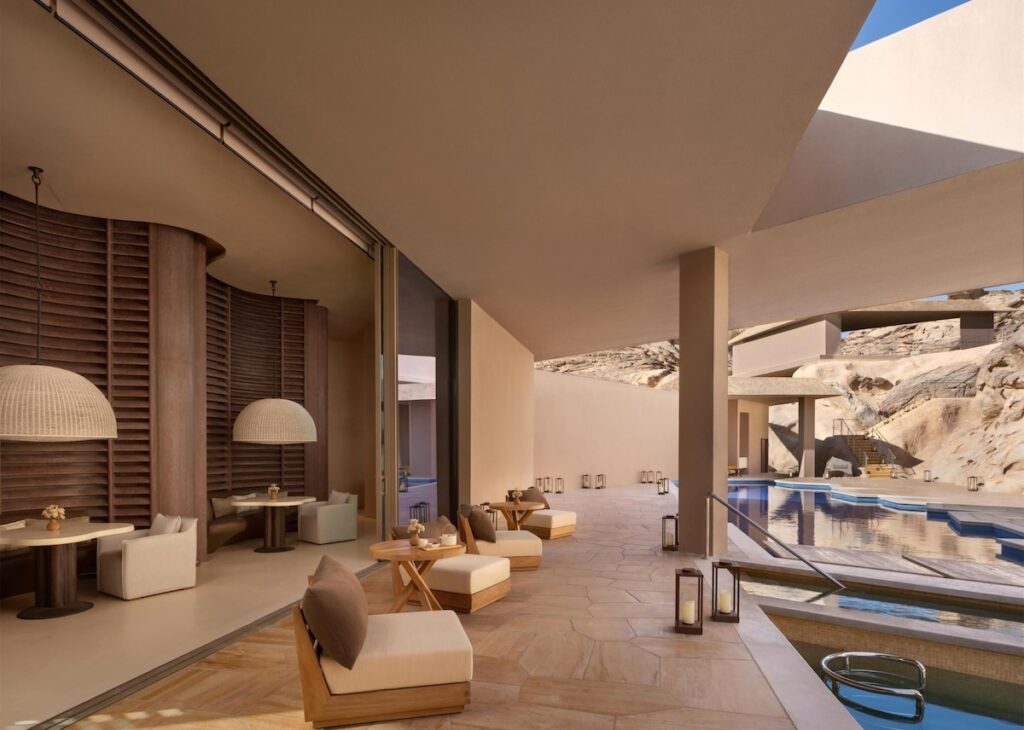 Lounge aberto integrado à piscina e área externa do Desert Rock Hotel.