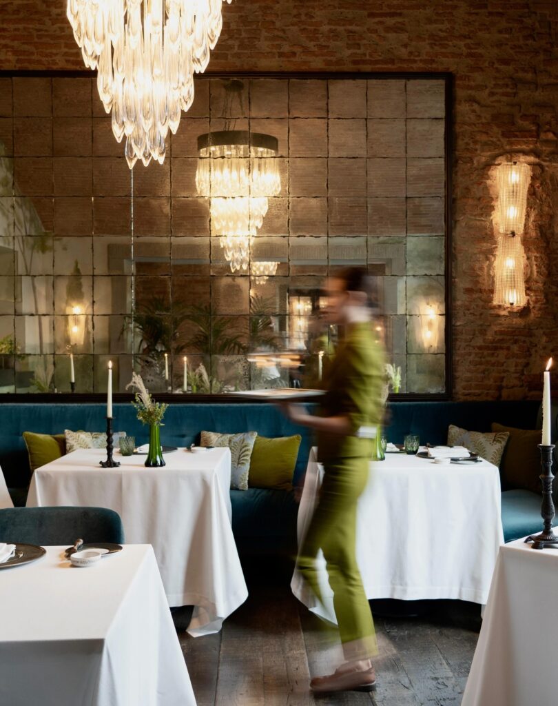 Salão nobre com espelho e tijolos no Saporium, um dos restaurantes mais bonitos na Itália.