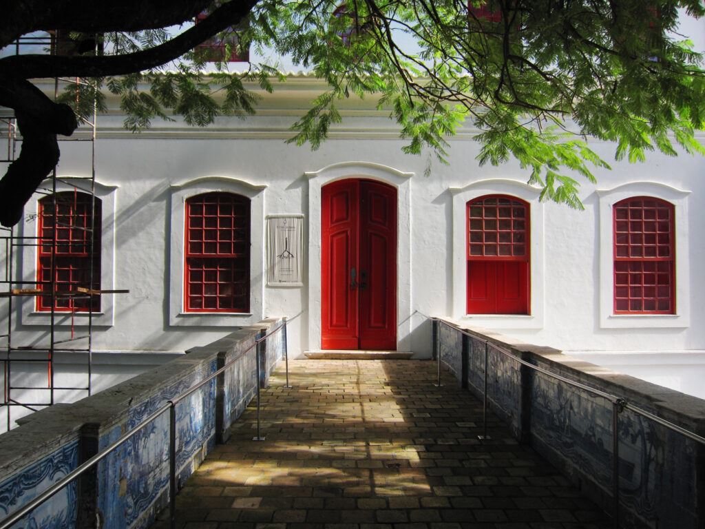 Ponte de acesso com azulejos portugueses e fachada colonial com portas vermelhas de Lina Bo Bardi no mam ba em Salvador.